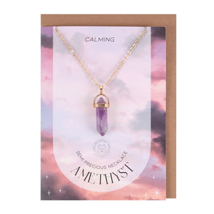Amethyst Crystal Necklace With Card.  This lovely greeting card features a gold-tone necklace with semi-precious amethyst crystal pendant to promote relaxation.  22cm chain with lobster clasp closure. Nickel-free stainless steel. Includes envelope.  Card left blank inside.