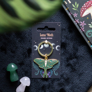 Luna Moth Keyring.  This ethereal keyring features an enameled, gold-tone luna moth charm on a matching backing card. 