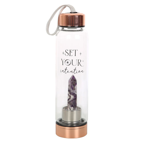 Amethyst Set You Intention Glass Water Bottle. Amplify your inner power with the claimed health benefits of crystals with this amethyst-infused glass water bottle with trendy 'Set your intentions' text.  Thsi bottle features a natural crystal point on a screw-off stainless steel base for easy cleaning, a rubberised anti-slip bottom, and a stainless steel screw lid with loop strap.