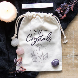 Cotton Crystal Bag. Keep crystals and tumblestones safe and tidy with this cotton drawstring storage bag. Features a sparking crystal design and 'My Crystals' text that's a must-have for any witch.   Measures 20cm x 15cm x 1cm.