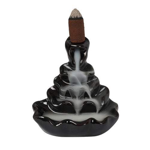 This ceramic backflow incense burner is specially designed to create smoke that cascades downwards, pouring dramatically down with a stunning rippling effect.  Once you have lit your incense cone, it will begin to smoke, the incense is heavier than air and it will fall dramatically in swirls and twists, through the hole and down over the item, to pool at the bottom. It is incredible to watch and very relaxing. 