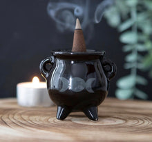 Load image into Gallery viewer, Triple Moon Cauldron Ceramic Holder.  Whether used with incense sticks or cones, this ceramic cauldron incense holder makes a quirky gift for any witch.  A printed triple moon design finishes off this unique design.